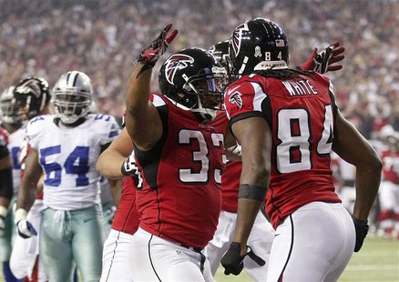 Atlanta Falcons running back Michael Turner (33) celebrates with teammate and wide receiver Roddy White (84) after a touchdown against the D Atlanta Falcons running back Michael Turner (33) celebrates with teammate and wide receiver Roddy White (84) after a touchdown against the D