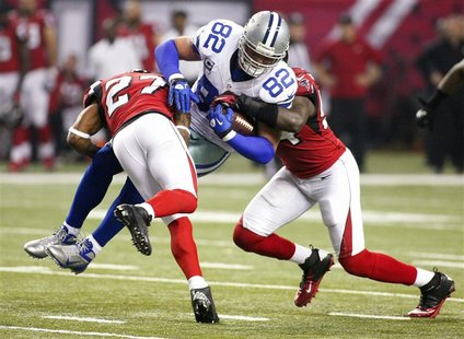 Dallas Cowboys tight end Jason Witten (82), gets hit by Atlanta Falcons cornerback Robert McClain (27), and linebacker Stephen Nicholas in t Dallas Cowboys tight end Jason Witten (82), gets hit by Atlanta Falcons cornerback Robert McClain (27), and linebacker Stephen Nicholas in t