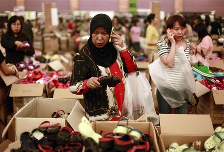 A woman picks a pair of Crocs footwear for her child during its sale at Central Park shopping mall in Jakarta in this August 16, 2011 file p A woman picks a pair of Crocs footwear for her child during its sale at Central Park shopping mall in Jakarta in this August 16, 2011 file p