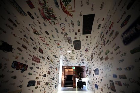 A woman walks past a tunnel of Google homepage logos at the Google campus near Venice Beach, in Los Angeles, California January 13, 2012. RE A woman walks past a tunnel of Google homepage logos at the Google campus near Venice Beach, in Los Angeles, California January 13, 2012. RE