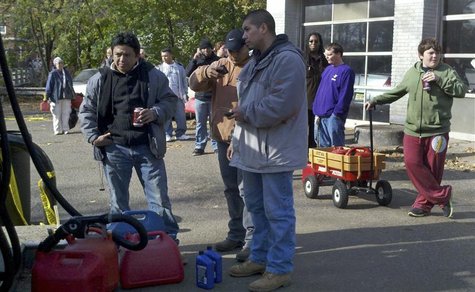 Middle-schooler Liam Kafrissen (R), stands in line with a little red wagon waiting to fill gas cans in hard-hit Maplewood, New Jersey Novemb Middle-schooler Liam Kafrissen (R), stands in line with a little red wagon waiting to fill gas cans in hard-hit Maplewood, New Jersey Novemb