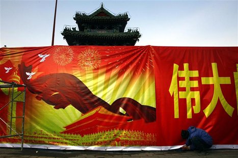 A worker installs a propaganda banner, promoting the Communist Party congress, outside the 700-year-old Dongyue Temple in central Beijing No A worker installs a propaganda banner, promoting the Communist Party congress, outside the 700-year-old Dongyue Temple in central Beijing No