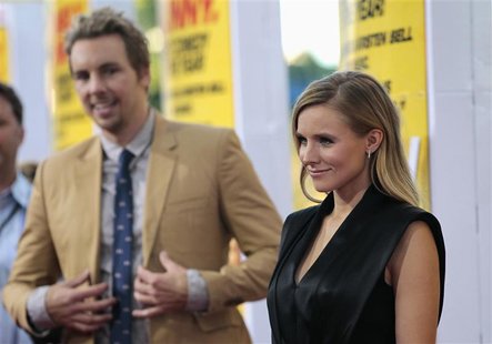 Cast member Kristen Bell poses, as her fiance and co-star Dax Shepard watches, at the premiere of "Hit and Run" at Regal Cinemas in Los Ange Cast member Kristen Bell poses, as her fiance and co-star Dax Shepard watches, at the premiere of "Hit and Run" at Regal Cinemas in Los Ange