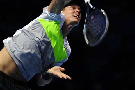 Tomas Berdych of Czech Republic serves to Andy Murray of Britain during their men's singles tennis match at the ATP World Tour Finals in the Tomas Berdych of Czech Republic serves to Andy Murray of Britain during their men's singles tennis match at the ATP World Tour Finals in the