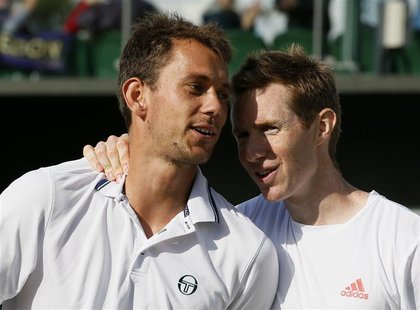 Frederik Nielsen of Denmark (L) and Jonathan Marray of Britain embrace after defeating Bob Bryan of the U.S. and Mike Bryan of the U.S. in t Frederik Nielsen of Denmark (L) and Jonathan Marray of Britain embrace after defeating Bob Bryan of the U.S. and Mike Bryan of the U.S. in t