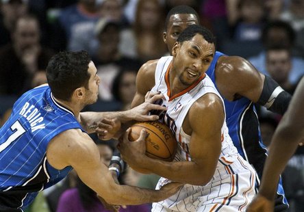 Charlotte Bobcats guard Gerald Henderson (C) fights for control of the ball against Orlando Magic shooting guard J.J. Redick (L) in their NB Charlotte Bobcats guard Gerald Henderson (C) fights for control of the ball against Orlando Magic shooting guard J.J. Redick (L) in their NB