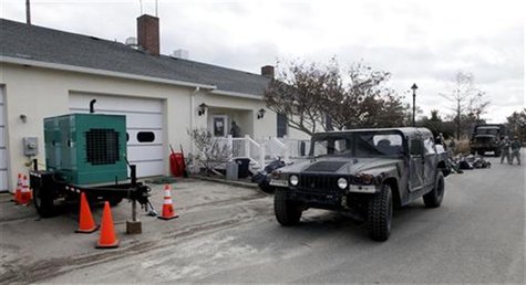 An electrical generator and military vehicle are parked outside the Bay Head Fire Company providing power so that people can vote in the aft An electrical generator and military vehicle are parked outside the Bay Head Fire Company providing power so that people can vote in the aft