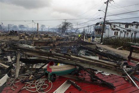 Homes that are devastated by fire and the effects of Hurricane Sandy are seen at the Breezy Point section of the Queens borough of New York Homes that are devastated by fire and the effects of Hurricane Sandy are seen at the Breezy Point section of the Queens borough of New York