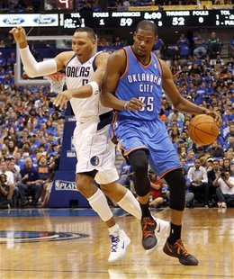 Oklahoma City Thunder forward Kevin Durant and Dallas Mavericks forward Shawn Marion collide during the second half of their NBA Western Con Oklahoma City Thunder forward Kevin Durant and Dallas Mavericks forward Shawn Marion collide during the second half of their NBA Western Con