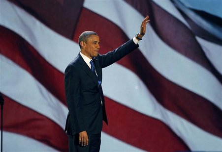 U.S. President Barack Obama, who won a second term in office by defeating Republican presidential nominee Mitt Romney, waves as he addresses U.S. President Barack Obama, who won a second term in office by defeating Republican presidential nominee Mitt Romney, waves as he addresses