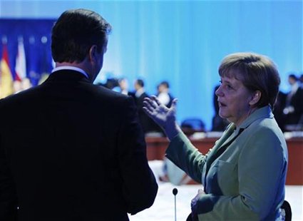 German Chancellor Angela Merkel (R) talks with Britain's Prime Minister David Cameron before the first session of the G20 Summit in Los Cabo German Chancellor Angela Merkel (R) talks with Britain's Prime Minister David Cameron before the first session of the G20 Summit in Los Cabo