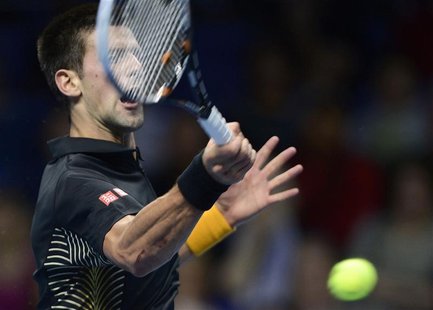 Serbia's Novak Djokovic hits a return to Britain's Andy Murray during their men's singles tennis match at the ATP World Tour Finals in the O Serbia's Novak Djokovic hits a return to Britain's Andy Murray during their men's singles tennis match at the ATP World Tour Finals in the O