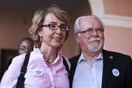 Former congresswoman Gabrielle Giffords and Congressman Ron Barber leave the Pima County Recorder's office after casting their ballots in do Former congresswoman Gabrielle Giffords and Congressman Ron Barber leave the Pima County Recorder's office after casting their ballots in do
