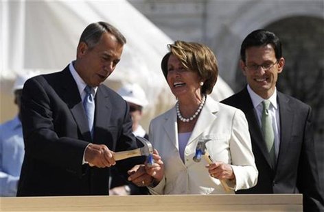 U.S. House Minority Leader Nancy Pelosi (C) (D-CA) reacts as U.S. House Speaker John Boehner (L) (R-OH) helps hammer in her nail, as House M U.S. House Minority Leader Nancy Pelosi (C) (D-CA) reacts as U.S. House Speaker John Boehner (L) (R-OH) helps hammer in her nail, as House M