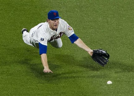 New York Mets left fielder Jason Bay makes a diving attempt to catch a lead-off single by Washington Nationals batter Roger Bernadina in the New York Mets left fielder Jason Bay makes a diving attempt to catch a lead-off single by Washington Nationals batter Roger Bernadina in the