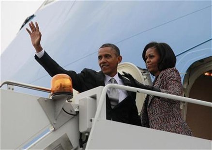 U.S. President Barack Obama and first lady Michelle Obama wave from Air Force One in Chicago, November 7, 2012 following the U.S. presidenti U.S. President Barack Obama and first lady Michelle Obama wave from Air Force One in Chicago, November 7, 2012 following the U.S. presidenti