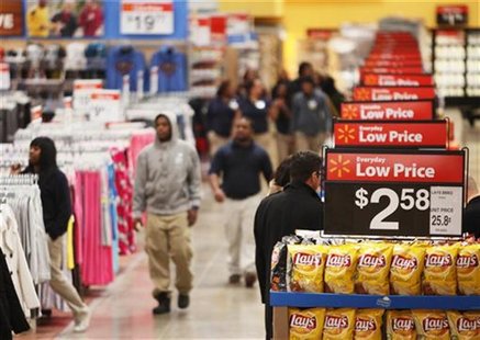 Workers walk through a new Wal-Mart store in Chicago, January 24, 2012. REUTERS/John Gress Workers walk through a new Wal-Mart store in Chicago, January 24, 2012. REUTERS/John Gress