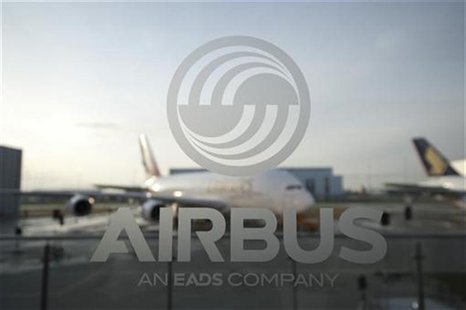 An A380 aircraft is seen through a window with an Airbus logo during the EADS / Airbus 'New Year Press Conference' in Hamburg January 17, 20 An A380 aircraft is seen through a window with an Airbus logo during the EADS / Airbus 'New Year Press Conference' in Hamburg January 17, 20