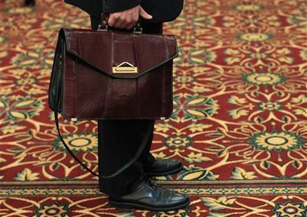 A man holds his briefcase while waiting in line during a job fair in Melville, New York July 19, 2012. REUTERS/Shannon Stapleton A man holds his briefcase while waiting in line during a job fair in Melville, New York July 19, 2012. REUTERS/Shannon Stapleton