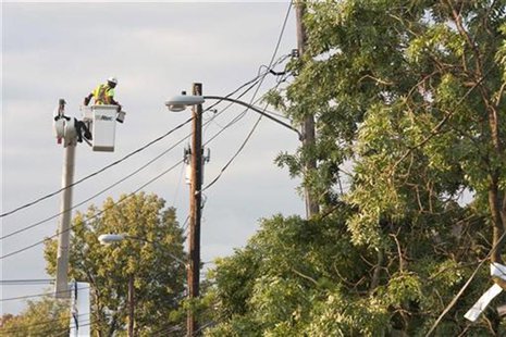 A utility worker repairs damage to power lines the morning after the town was hit by a tornado in Elmira, New York July 27, 2012. REUTERS/Ad A utility worker repairs damage to power lines the morning after the town was hit by a tornado in Elmira, New York July 27, 2012. REUTERS/Ad