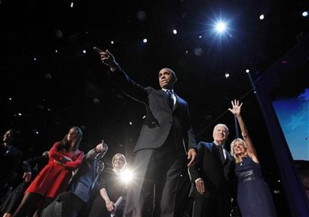 U.S. President Barack Obama gestures onstage during his election night victory rally in Chicago November 7, 2012. Beside Obama are Vice Pres U.S. President Barack Obama gestures onstage during his election night victory rally in Chicago November 7, 2012. Beside Obama are Vice Pres