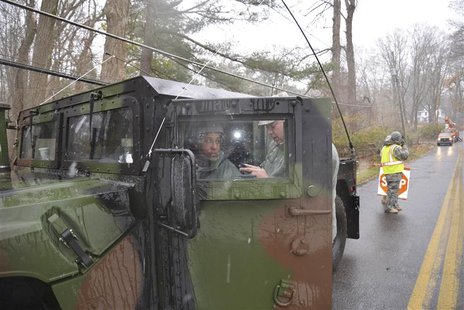 New York Air National Guardsmen guard downed power lines in Westchester County, New York in the aftermath of severe storm damage caused by H New York Air National Guardsmen guard downed power lines in Westchester County, New York in the aftermath of severe storm damage caused by H