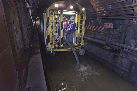 MTA employees use a pump train and work around the clock to remove seawater out of the L train's tunnel under the East River in the aftermat MTA employees use a pump train and work around the clock to remove seawater out of the L train's tunnel under the East River in the aftermat