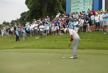 Thomas Bjorn of Denmark putts on the ninth hole during the rain-delayed second round of the Barclays Singapore Open golf tournament in Sento Thomas Bjorn of Denmark putts on the ninth hole during the rain-delayed second round of the Barclays Singapore Open golf tournament in Sento