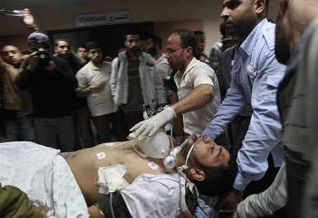 A wounded Palestinian is wheeled on a stretcher at a hospital in Gaza City following Israeli shelling November 10, 2012. REUTERS/Mohammed Sa A wounded Palestinian is wheeled on a stretcher at a hospital in Gaza City following Israeli shelling November 10, 2012. REUTERS/Mohammed Sa