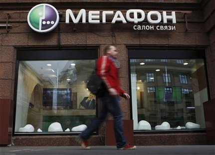 A man walks past a MegaFon retail outlet along a street in Moscow September 4, 2012. REUTERS/Maxim Shemetov A man walks past a MegaFon retail outlet along a street in Moscow September 4, 2012. REUTERS/Maxim Shemetov