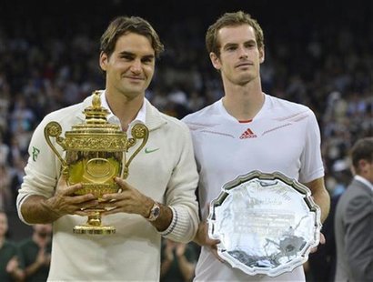 Roger Federer of Switzerland (L) holds his winners trophy and Andy Murray of Britain holds his runners-up trophy after Federer defeated Murr Roger Federer of Switzerland (L) holds his winners trophy and Andy Murray of Britain holds his runners-up trophy after Federer defeated Murr