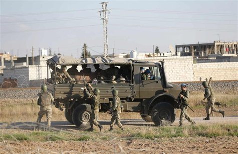 Turkish soldiers, with the northern Syrian town of Ras al-Ain in the background, change guards on the Turkish-Syrian border in Ceylanpinar, Turkish soldiers, with the northern Syrian town of Ras al-Ain in the background, change guards on the Turkish-Syrian border in Ceylanpinar,