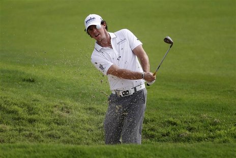 Rory McIlroy of Northern Ireland hits out of bunker on the first hole during the third round of the Barclays Singapore Open golf tournament Rory McIlroy of Northern Ireland hits out of bunker on the first hole during the third round of the Barclays Singapore Open golf tournament