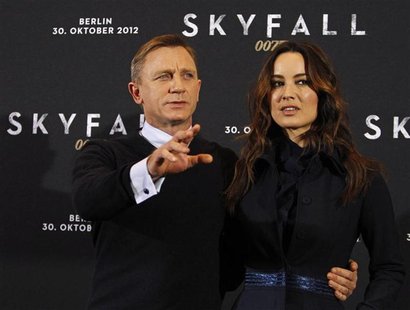 Cast members Daniel Craig (L) and Berenice Marlohe pose for photographers during a photocall to promote their film "Skyfall" in Berlin Octob Cast members Daniel Craig (L) and Berenice Marlohe pose for photographers during a photocall to promote their film "Skyfall" in Berlin Octob