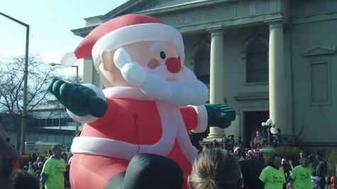 Santa makes his way down Park Street after doing a limbo dance to get under some traffic lights. Santa makes his way down Park Street after doing a limbo dance to get under some traffic lights.