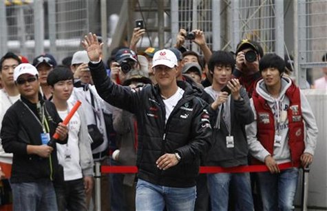 Mercedes Formula One driver Michael Schumacher of Germany waves to fans before an autograph signing session at the Korea International Circu Mercedes Formula One driver Michael Schumacher of Germany waves to fans before an autograph signing session at the Korea International Circu