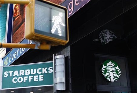A walk sign flashes in Times Square in front of a store bearing the new Starbucks logo in New York March 8, 2011. REUTERS/Lucas Jackson A walk sign flashes in Times Square in front of a store bearing the new Starbucks logo in New York March 8, 2011. REUTERS/Lucas Jackson