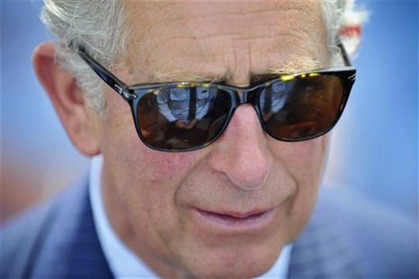 An emergency services member is reflected in the sunglasses of Britain's Prince Charles during a reception at Bondi Icebergs swimming club i An emergency services member is reflected in the sunglasses of Britain's Prince Charles during a reception at Bondi Icebergs swimming club i