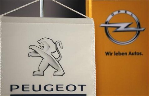 The logo of German General Motors daughter Opel and French car maker Peugeot are seen at a Opel and Peugeot dealership in Leverkusen near Co The logo of German General Motors daughter Opel and French car maker Peugeot are seen at a Opel and Peugeot dealership in Leverkusen near Co