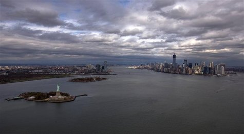The Statue of Liberty, Liberty Island and Ellis Islands are seen to the left next to New York's Lower Manhattan skyline in this aerial image The Statue of Liberty, Liberty Island and Ellis Islands are seen to the left next to New York's Lower Manhattan skyline in this aerial image