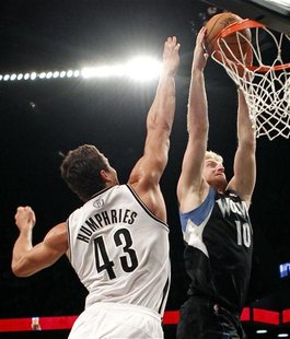 Minnesota Timberwolves forward Chase Budinger dunks the ball in front of Brooklyn Nets forward Kris Humphries in the first quarter of their Minnesota Timberwolves forward Chase Budinger dunks the ball in front of Brooklyn Nets forward Kris Humphries in the first quarter of their