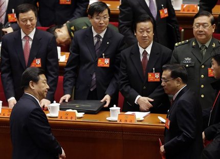 China's Vice President Xi Jinping (front L) and China's Vice-Premier Li Keqiang (front R) leave their seats after the closing session of 18t China's Vice President Xi Jinping (front L) and China's Vice-Premier Li Keqiang (front R) leave their seats after the closing session of 18t