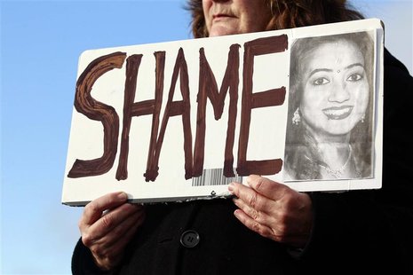 Mary Phelan holds a picture of Savita Halappanavar in protest outside University Hospital Galway in Galway, Ireland November 15, 2012. The I Mary Phelan holds a picture of Savita Halappanavar in protest outside University Hospital Galway in Galway, Ireland November 15, 2012. The I