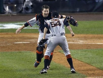 San Francisco Giants relief pitcher Sergio Romo (R) jumps into the arms of catcher Buster Posey (L) after defeating the Detroit Tigers to wi San Francisco Giants relief pitcher Sergio Romo (R) jumps into the arms of catcher Buster Posey (L) after defeating the Detroit Tigers to wi