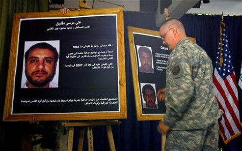 A U.S. solider shows a picture of Ali Mussa Daqduq (L) during a news conference at the heavily fortified Green Zone area in Baghdad July 2, A U.S. solider shows a picture of Ali Mussa Daqduq (L) during a news conference at the heavily fortified Green Zone area in Baghdad July 2,