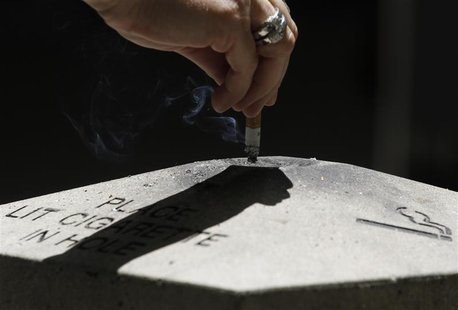 A woman disposes a cigarette in Los Angeles, California, May 31, 2012. REUTERS/Jonathan Alcorn A woman disposes a cigarette in Los Angeles, California, May 31, 2012. REUTERS/Jonathan Alcorn