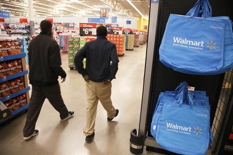 Workers walk through a new Wal-Mart store in Chicago, January 24, 2012. REUTERS/John Gress Workers walk through a new Wal-Mart store in Chicago, January 24, 2012. REUTERS/John Gress