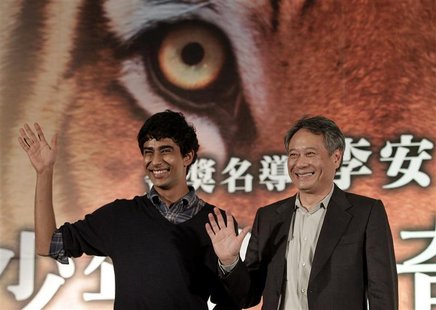 Taiwan-born director Ang Lee (R) and cast member Suraj Sharma of India wave during a news conference to promote their latest film "The Life Taiwan-born director Ang Lee (R) and cast member Suraj Sharma of India wave during a news conference to promote their latest film "The Life