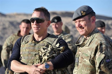 Actor Daniel Craig (L) speaks to military personnel during a visit to Camp Bastion in Helmand Province, Afghanistan November 18, 2012. Craig Actor Daniel Craig (L) speaks to military personnel during a visit to Camp Bastion in Helmand Province, Afghanistan November 18, 2012. Craig