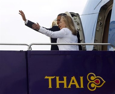 U.S. President Barack Obama and Secretary of State Hillary Clinton wave from the steps of Air Force One in Bangkok November 19, 2012. Poised U.S. President Barack Obama and Secretary of State Hillary Clinton wave from the steps of Air Force One in Bangkok November 19, 2012. Poised